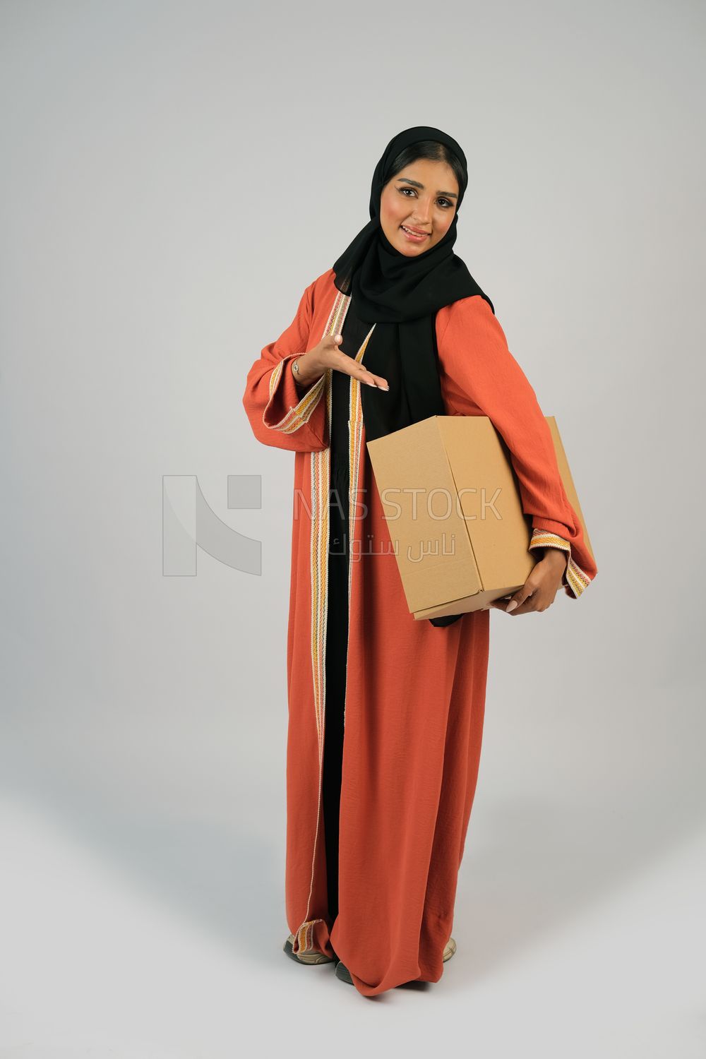 Saudi Gulf girl holding a cardboard delivery box