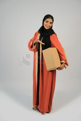 Saudi Gulf girl holding a cardboard delivery box