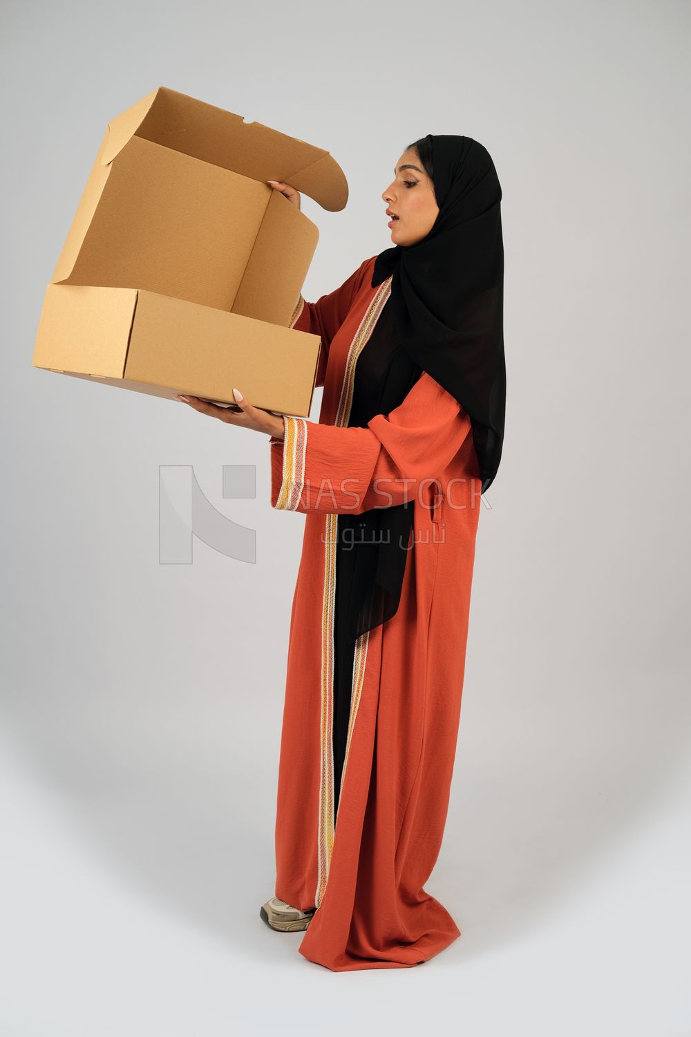 Saudi Gulf girl holding a cardboard delivery box