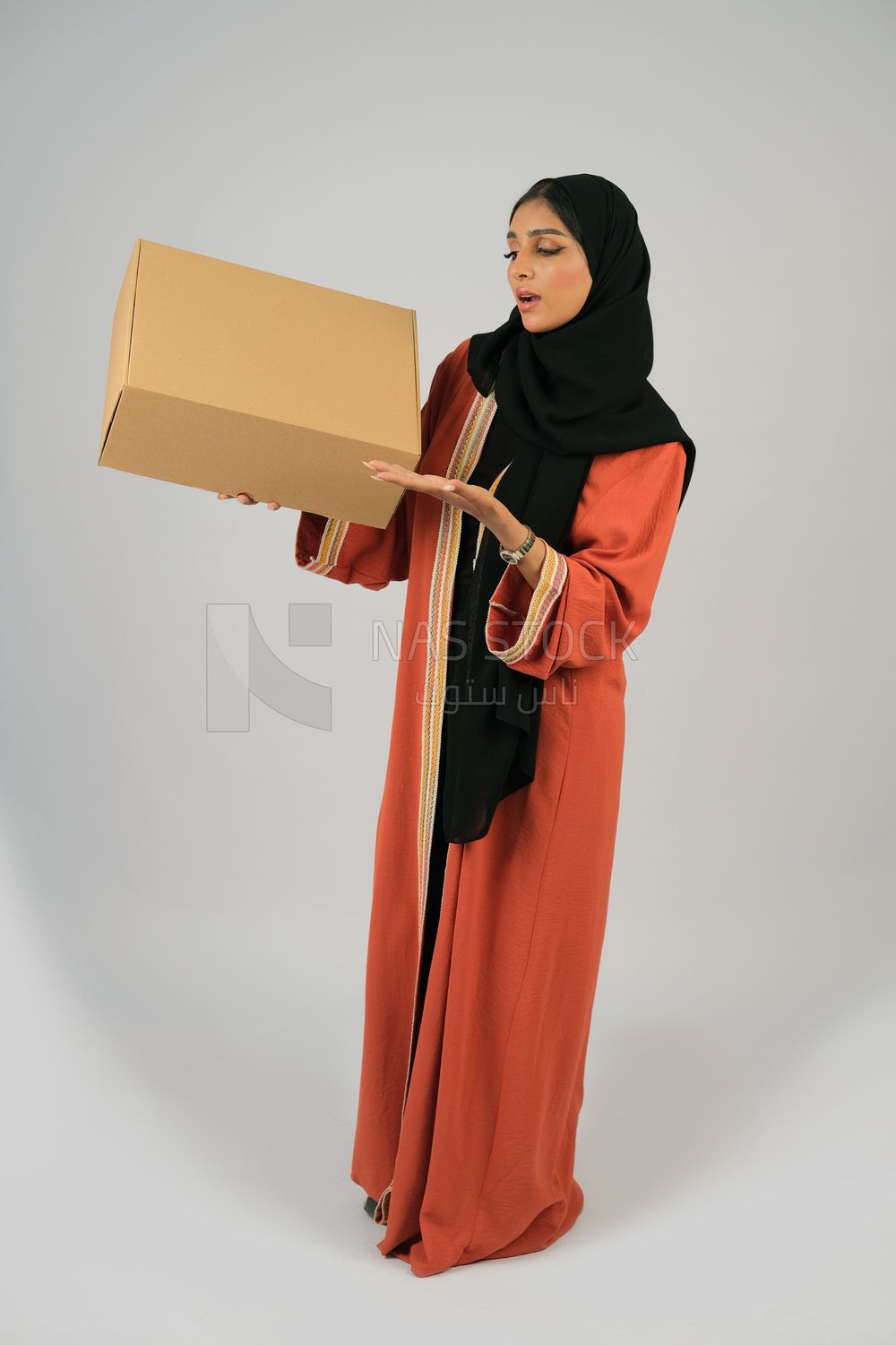 Saudi Gulf girl holding a cardboard delivery box