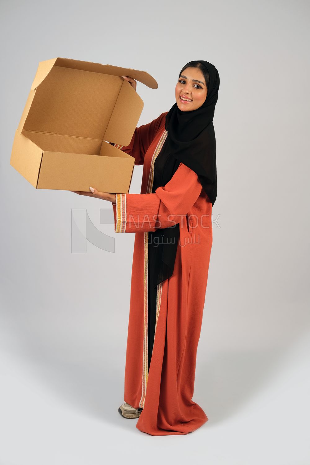 Saudi Gulf girl holding a cardboard delivery box
