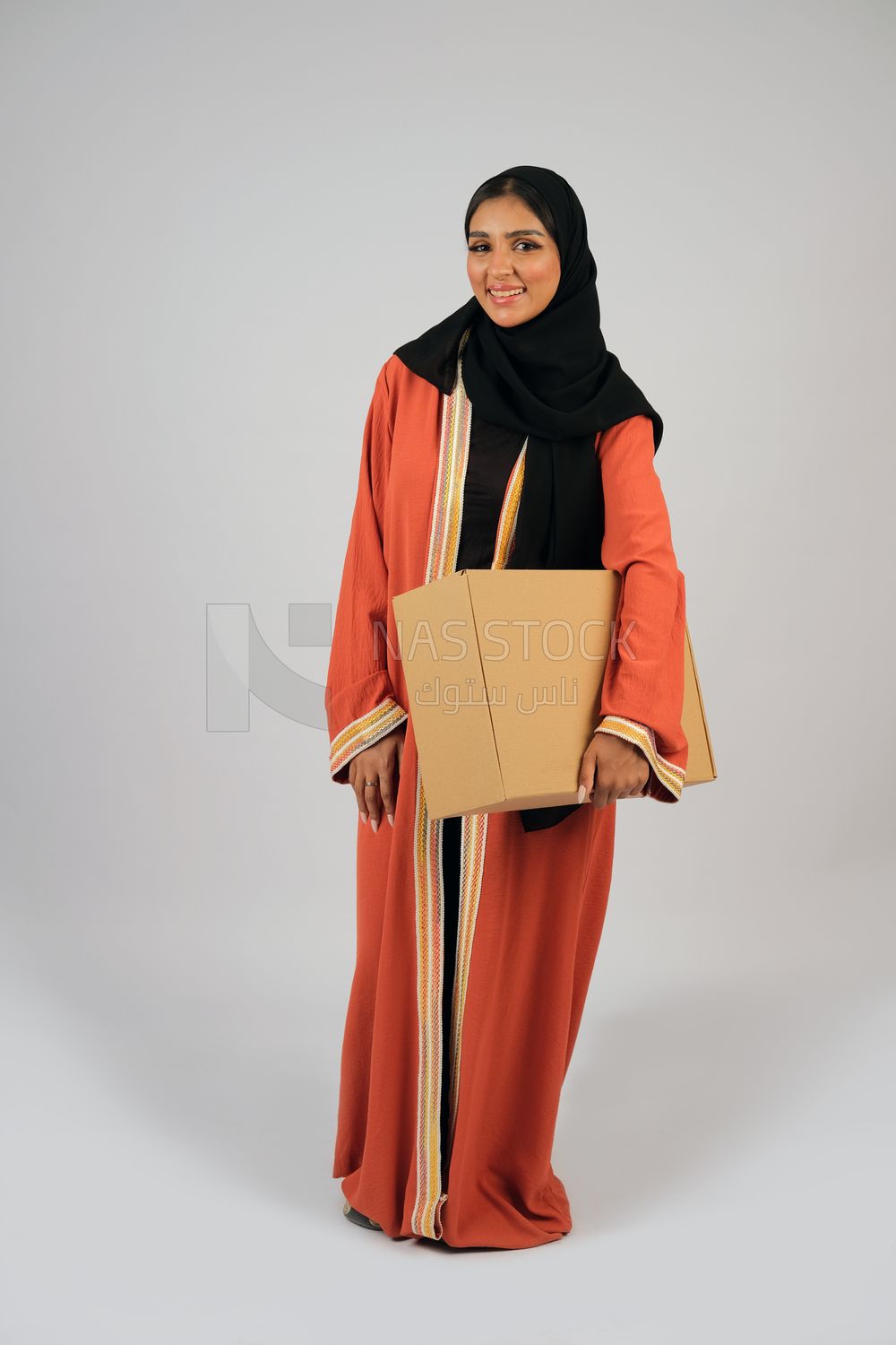 Saudi Gulf girl holding a cardboard delivery box