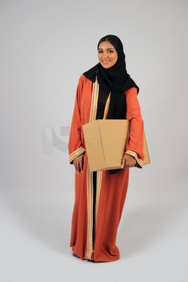 Saudi Gulf girl holding a cardboard delivery box
