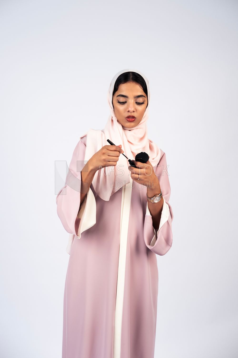 Saudi Gulf girl putting on makeup