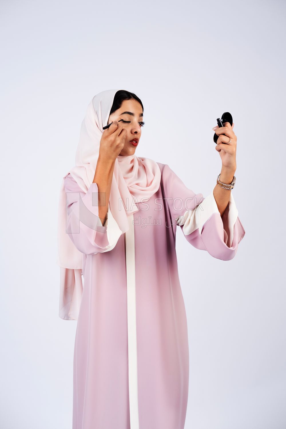 Saudi Gulf girl putting on makeup