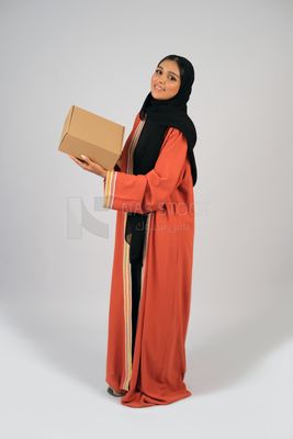 Saudi Gulf girl holding a cardboard delivery box
