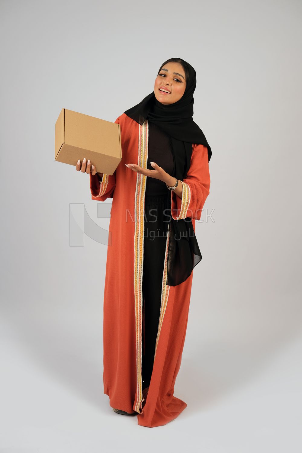 Saudi Gulf girl holding a cardboard delivery box