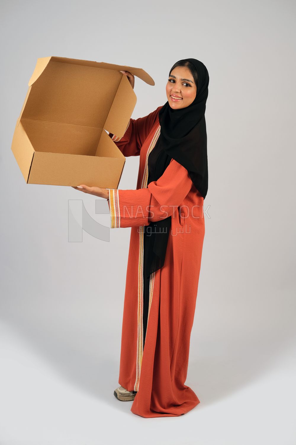Saudi Gulf girl holding a cardboard delivery box