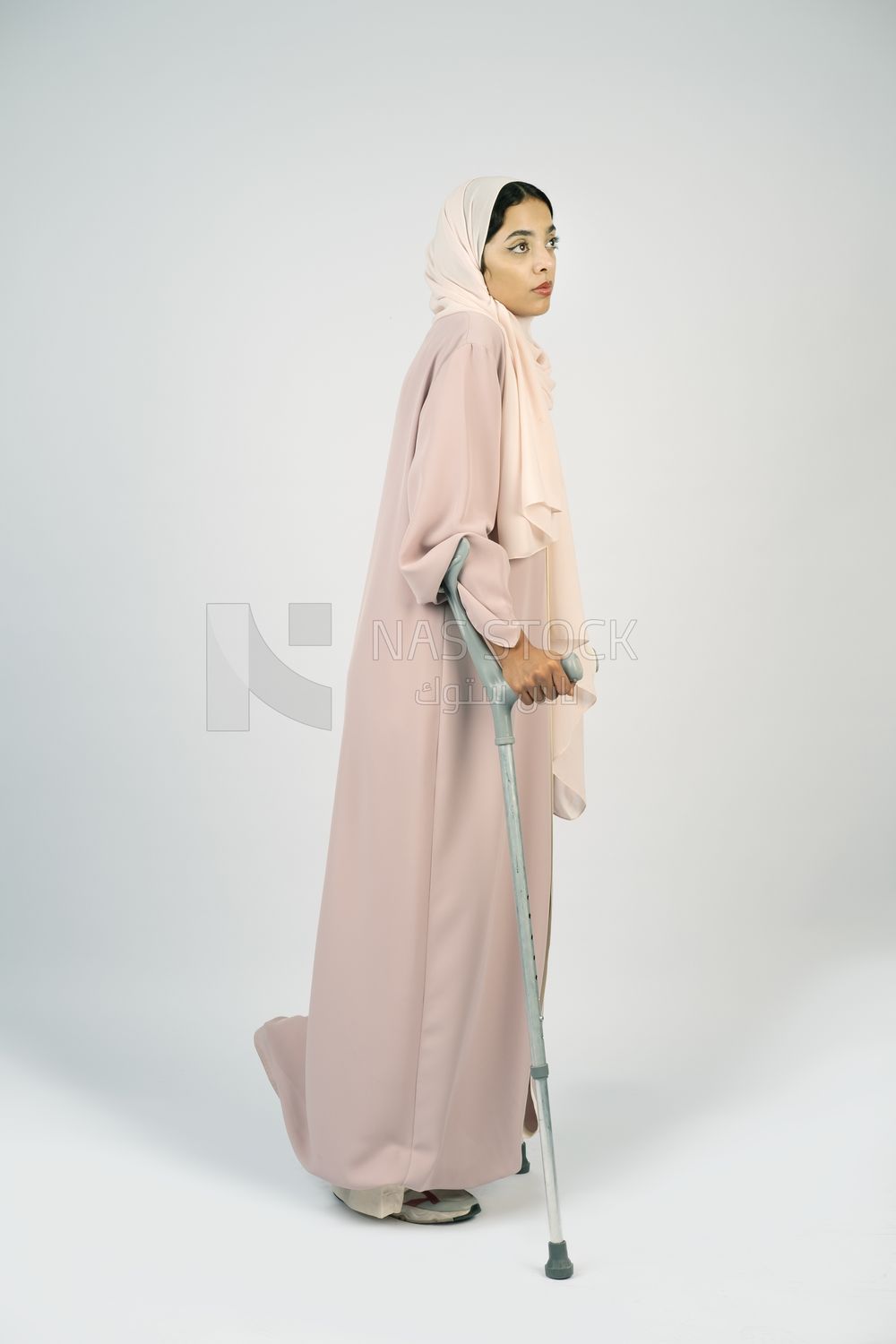 Saudi Gulf woman leaning on crutches