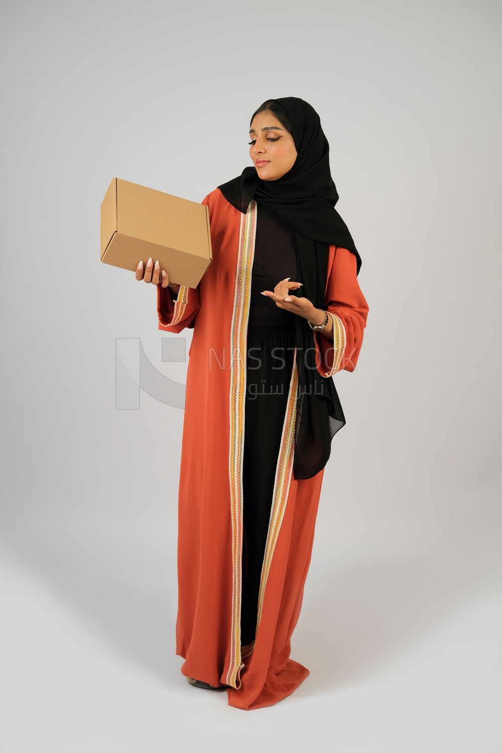 Saudi Gulf girl holding a cardboard delivery box