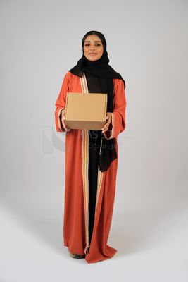 Saudi Gulf girl holding a cardboard delivery box