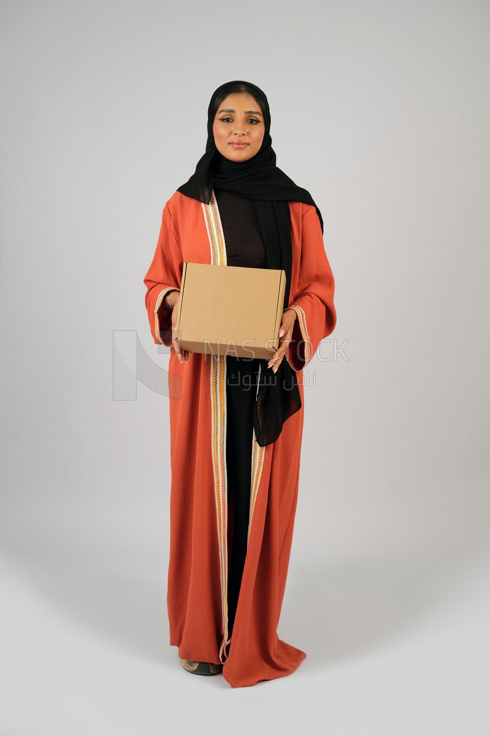 Saudi Gulf girl holding a cardboard delivery box