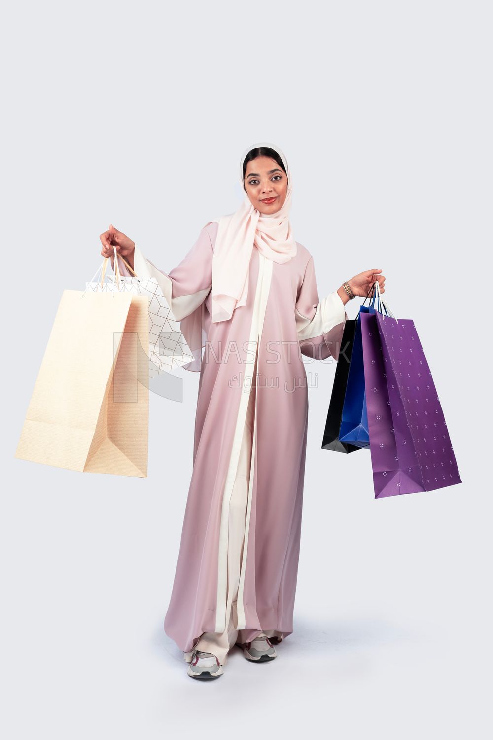 Gulf woman carrying colorful shopping bags