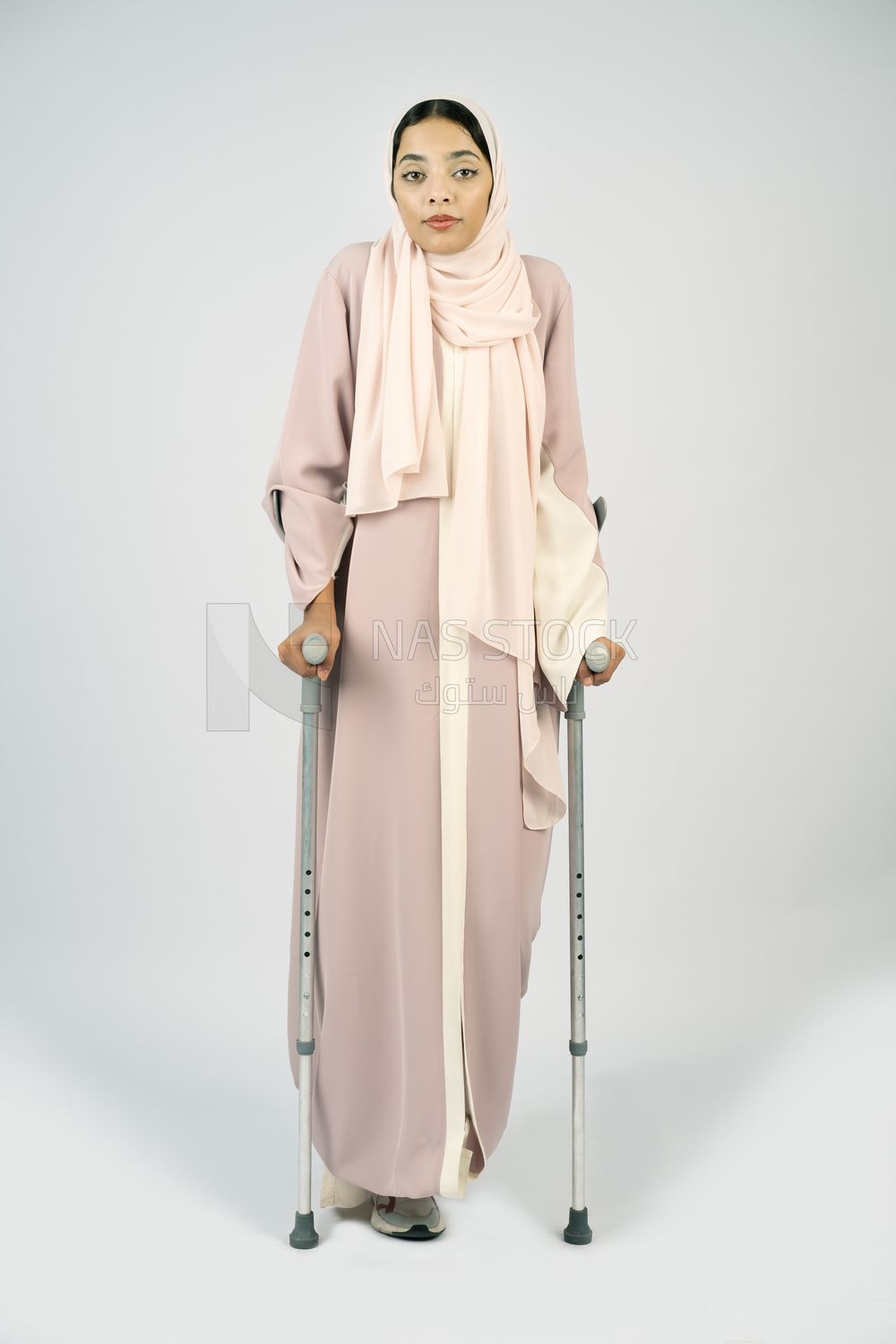 Saudi Gulf woman leaning on crutches