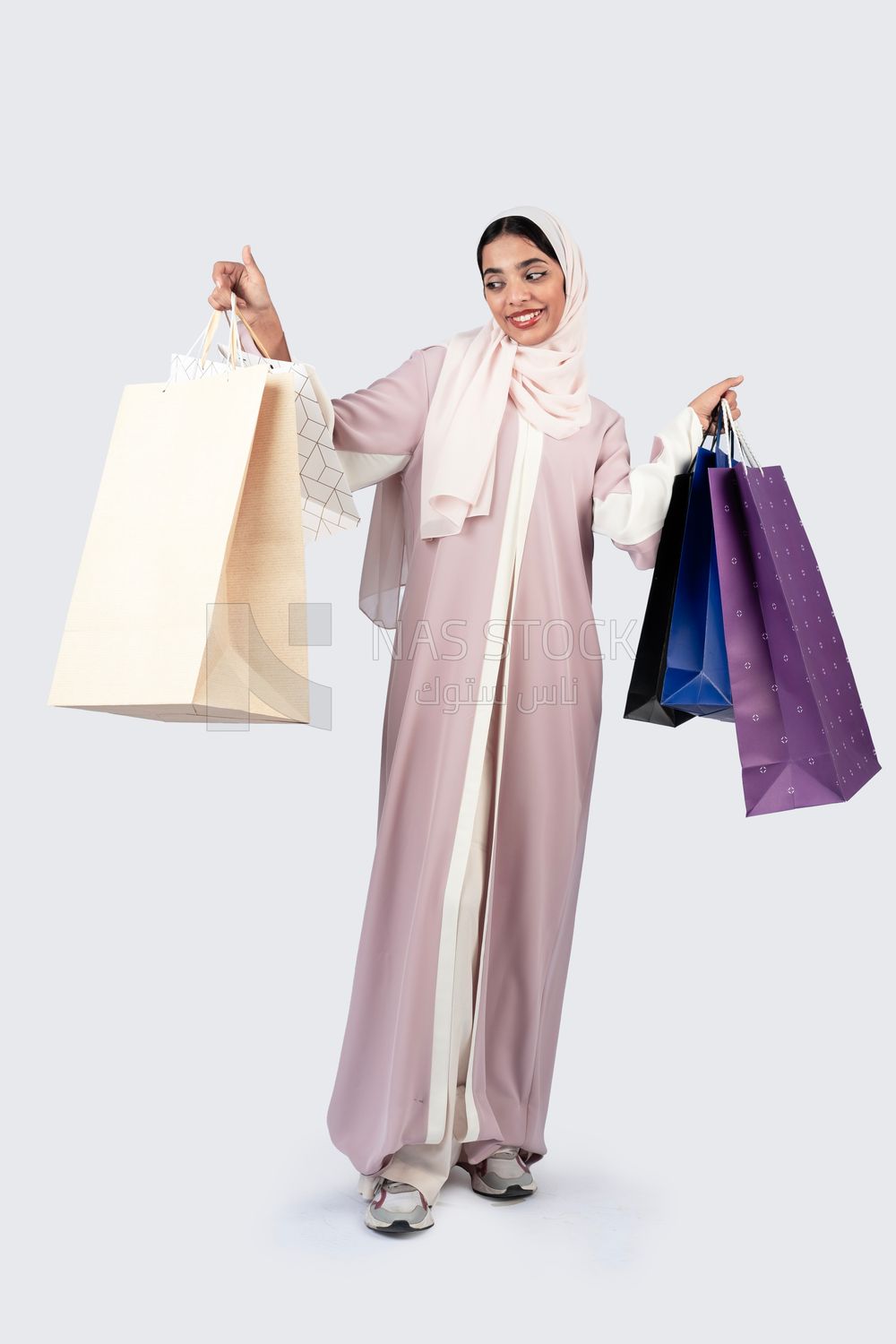 Gulf woman carrying colorful shopping bags