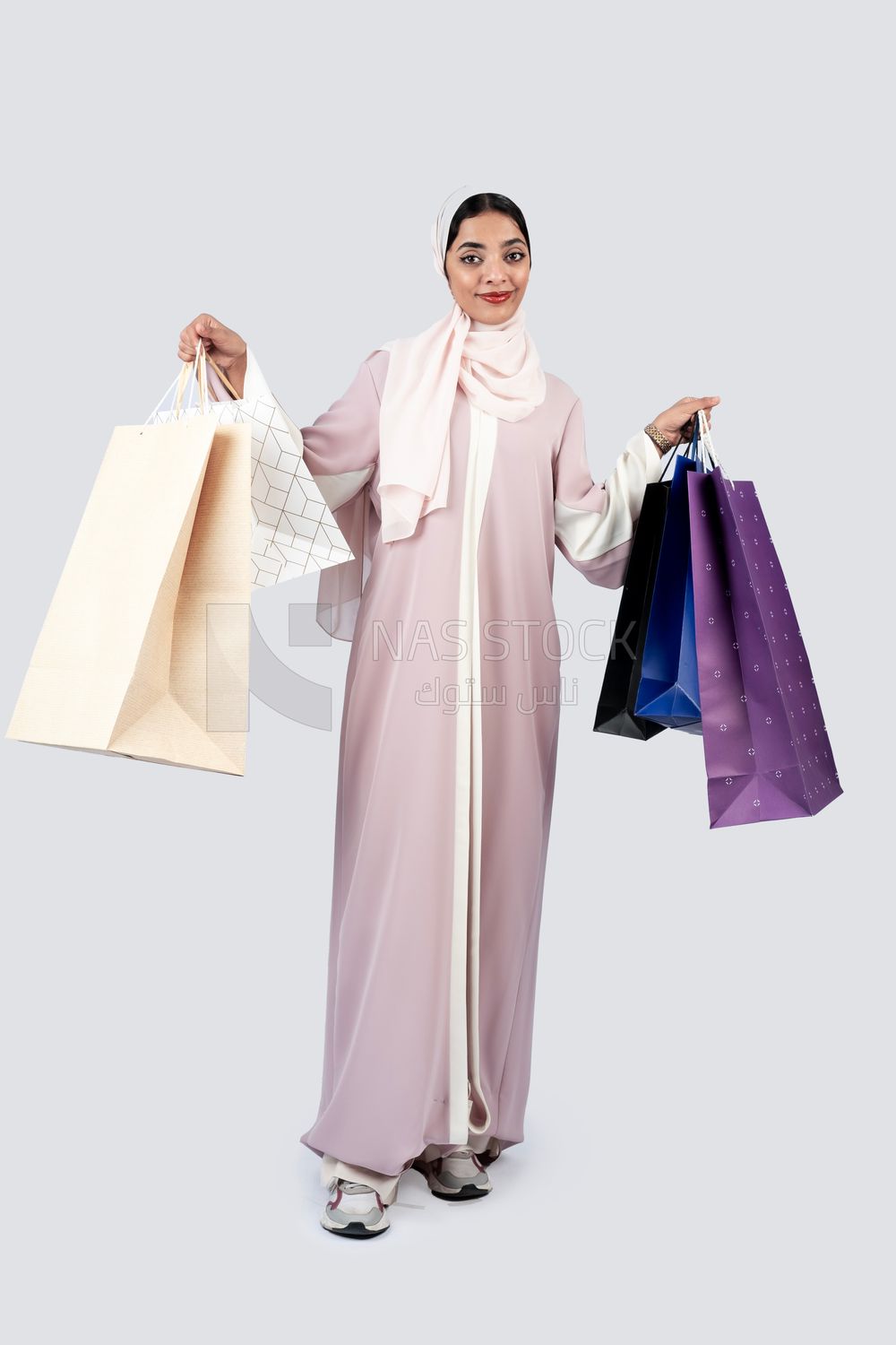 Gulf woman carrying colorful shopping bags