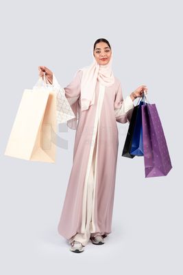 Gulf woman carrying colorful shopping bags