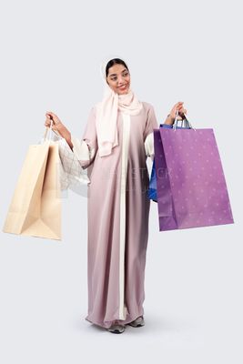 Gulf woman carrying colorful shopping bags