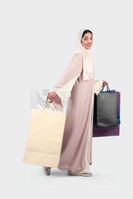 Gulf woman carrying colorful shopping bags