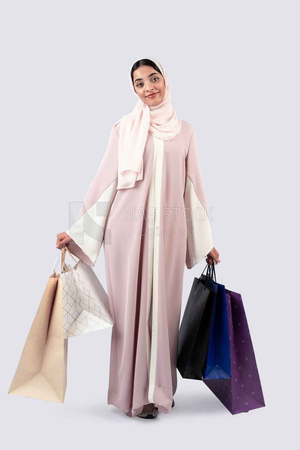 Gulf woman carrying colorful shopping bags