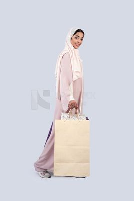 Gulf woman carrying colorful shopping bags