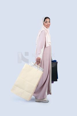 Gulf woman carrying colorful shopping bags