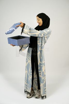Gulf girl holding blue gift box