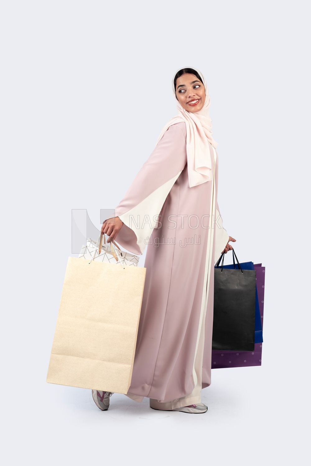 Gulf woman carrying colorful shopping bags