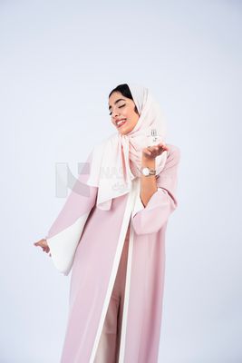 Gulf woman holding perfume bottle