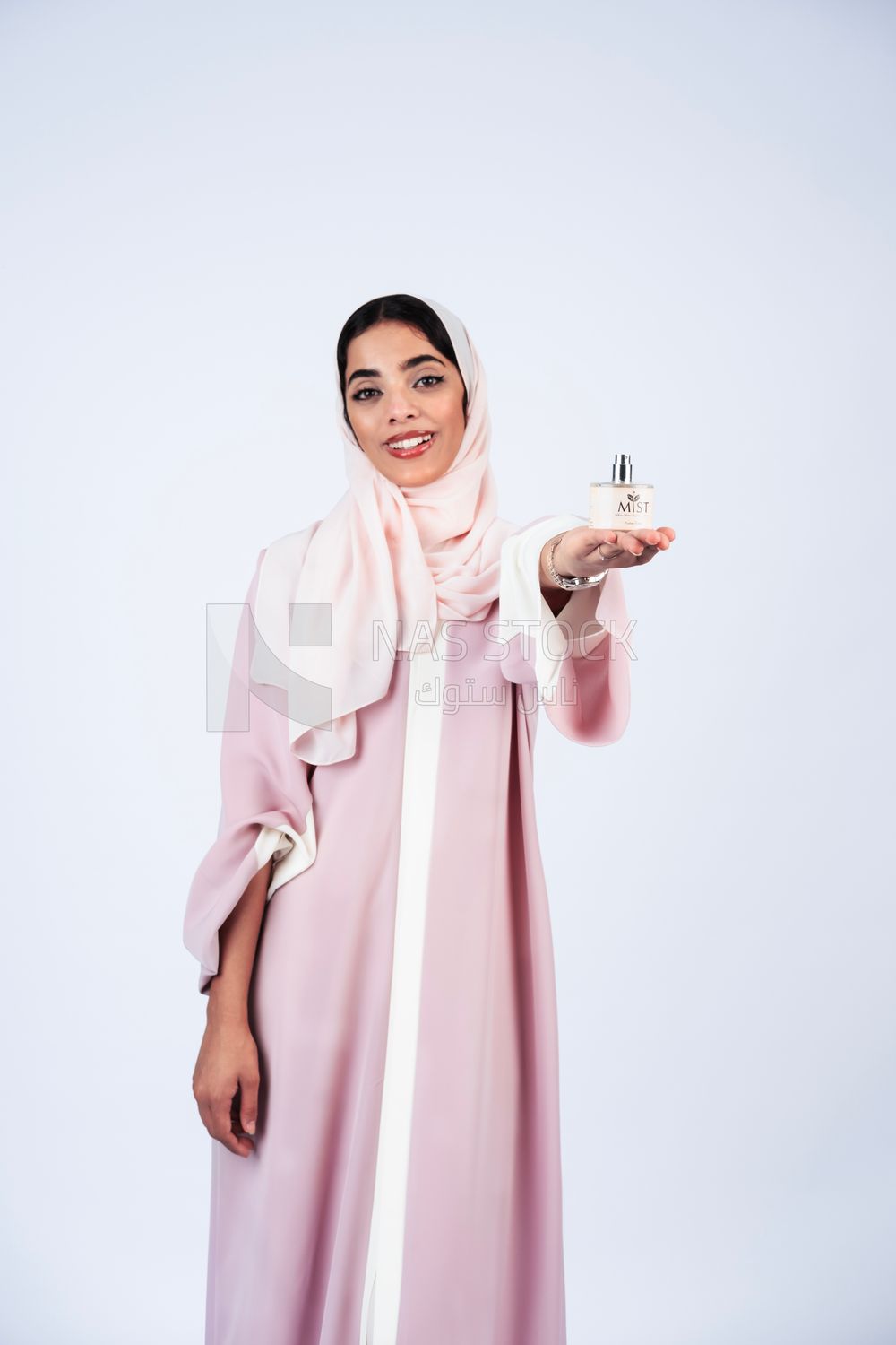 Gulf woman holding perfume bottle