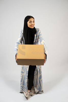 Gulf girl holding a special order box
