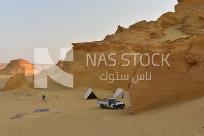 A scene of Bedouin tents and cars in the Wadi El Hitan desert in Egypt