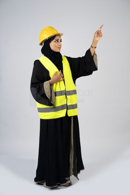 Veiled Gulf engineer wearing a safety suit and helmet