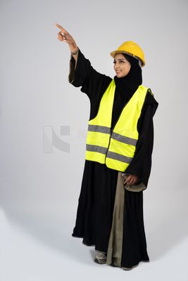 Veiled Gulf engineer wearing a safety suit and helmet