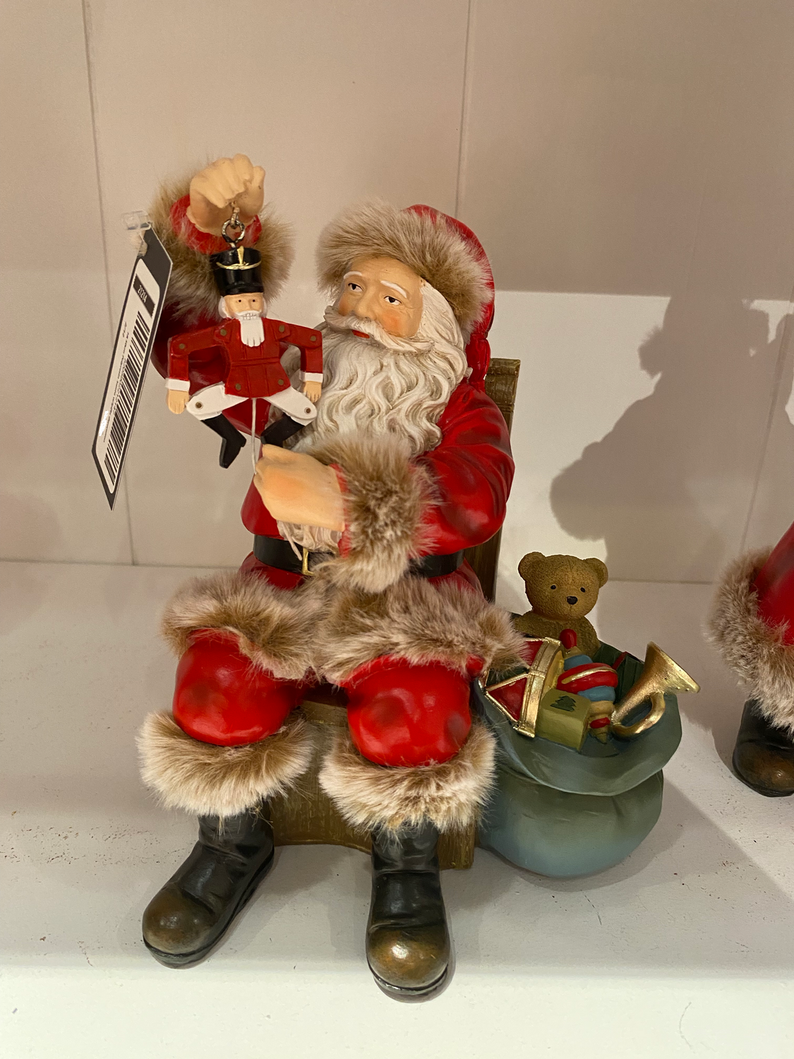 Père noel assis tenant marionette casse noisette