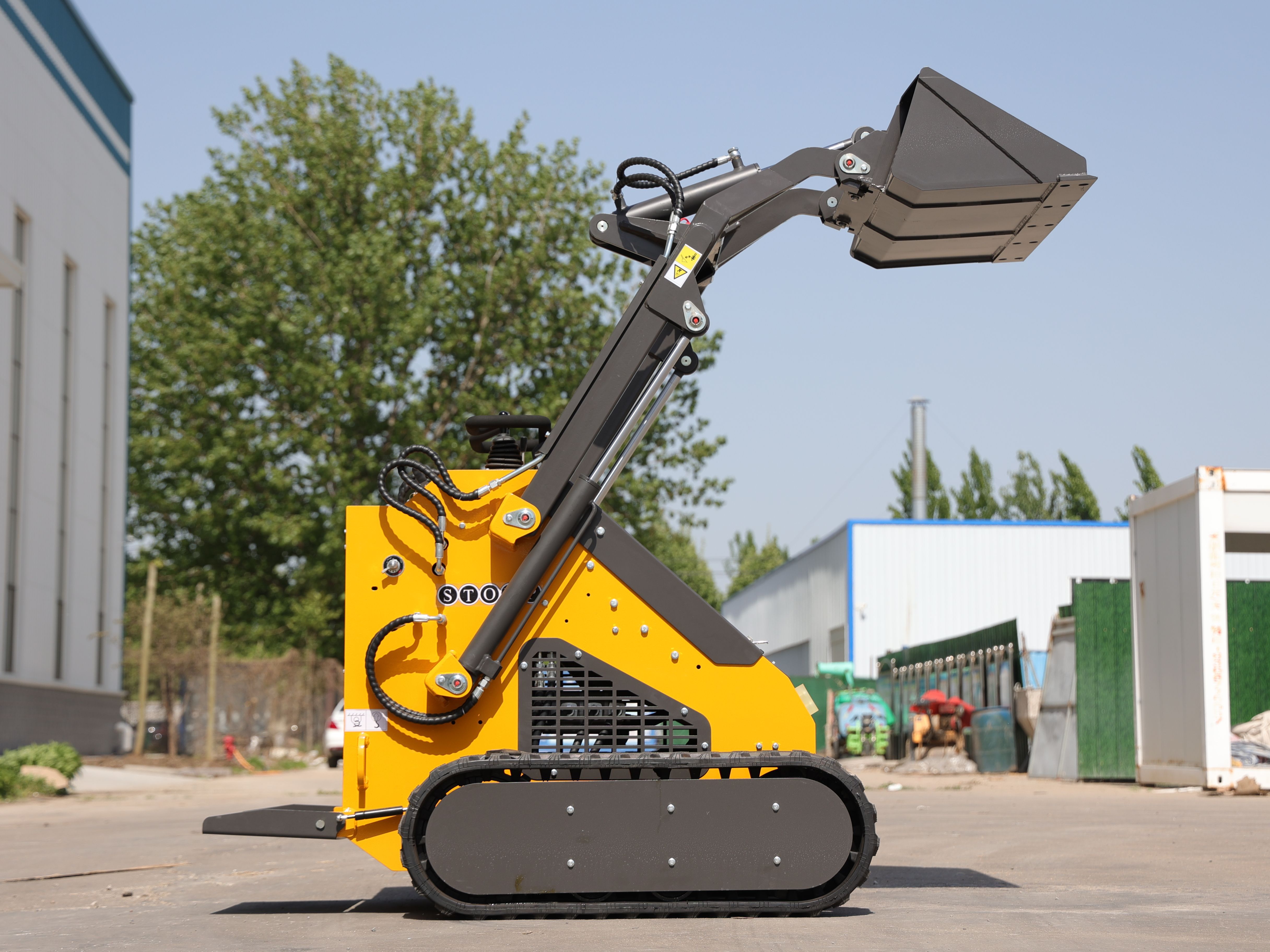 TYHPHON tracked skid steer loader lifting a bucket