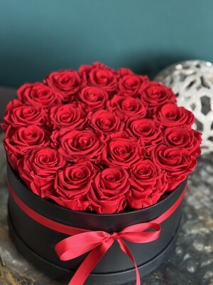 Round box with Red Forever roses