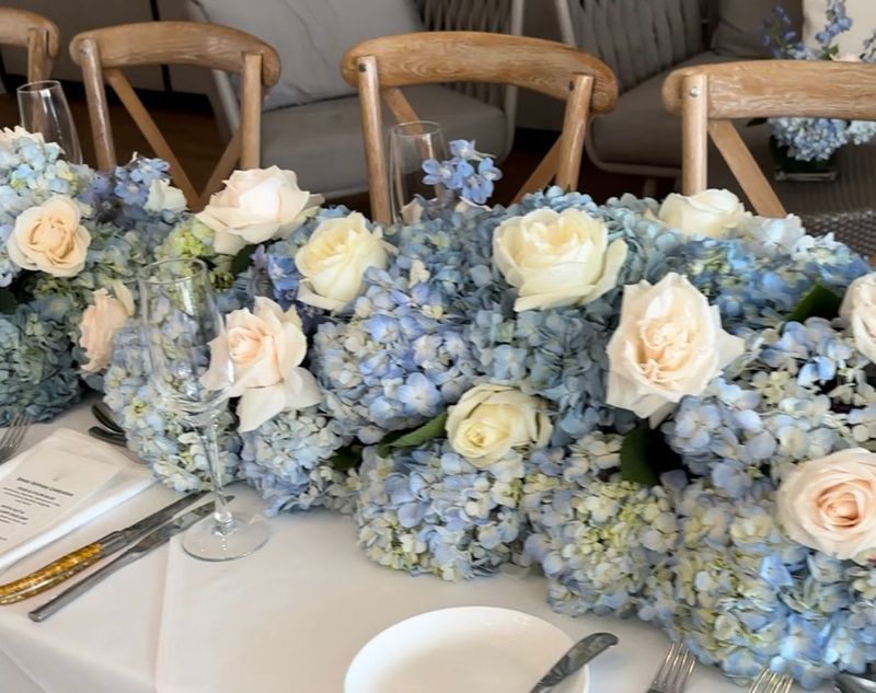 coastal white and blue flowers for a long farm table at a wedding at The Reeds at Shelter Haven in Stone Harbor NJ