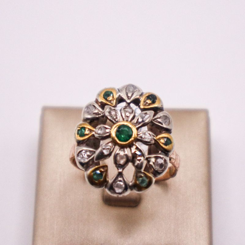 Anello vintage anni ’30 in oro 18 kt con smeraldo centrale e contorno floreale di diamanti e smeraldi.