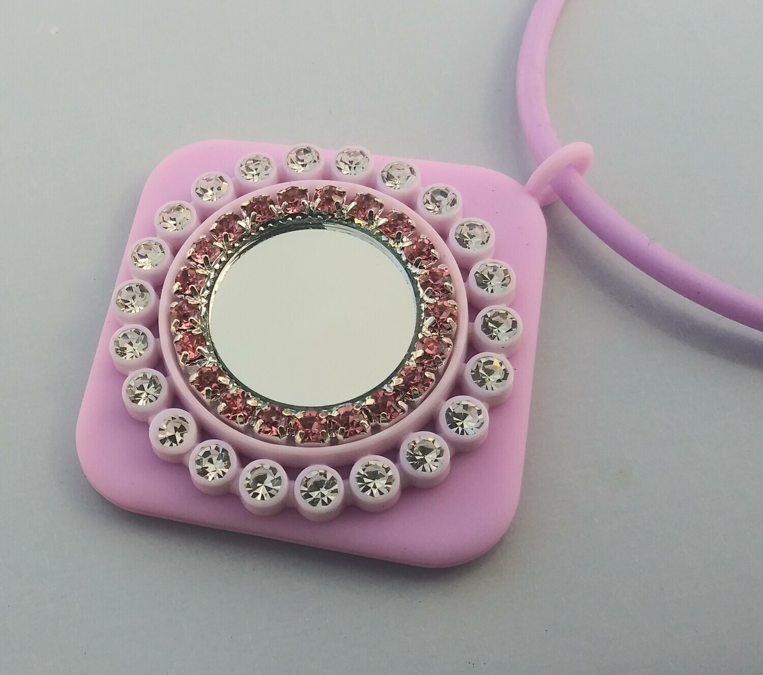 Double rings of rhinestones on pink square stretch rubber necklace