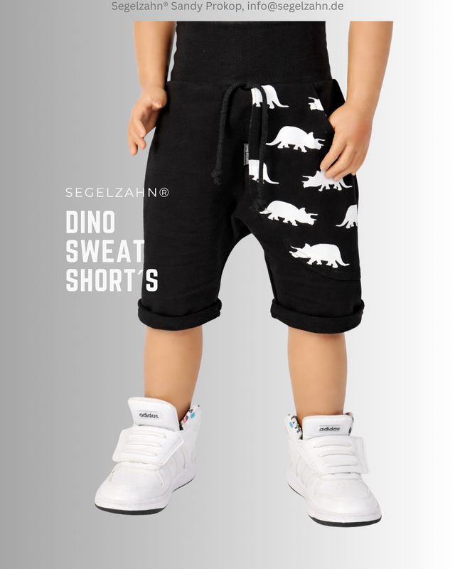 Shorts Kinder, schwarze Sweatshort Unisex mit Dino Seitentasche ( schwarz mit weißen Dinos ), Dekobändern und Softbündchen in