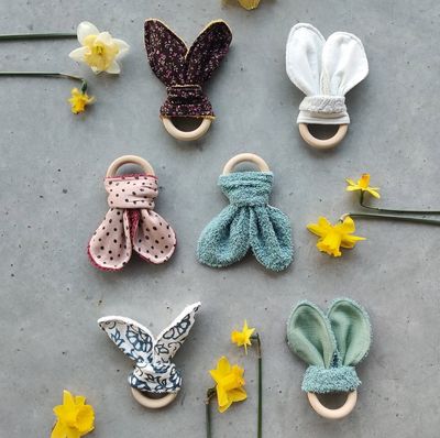 Wooden teething ring with rabbit ears out of recuperated textile