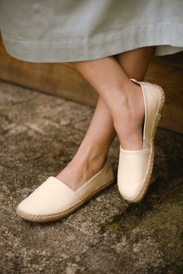 Espadrilles am Fuß im gekreuzten Sitz – entspannter Sommermoment