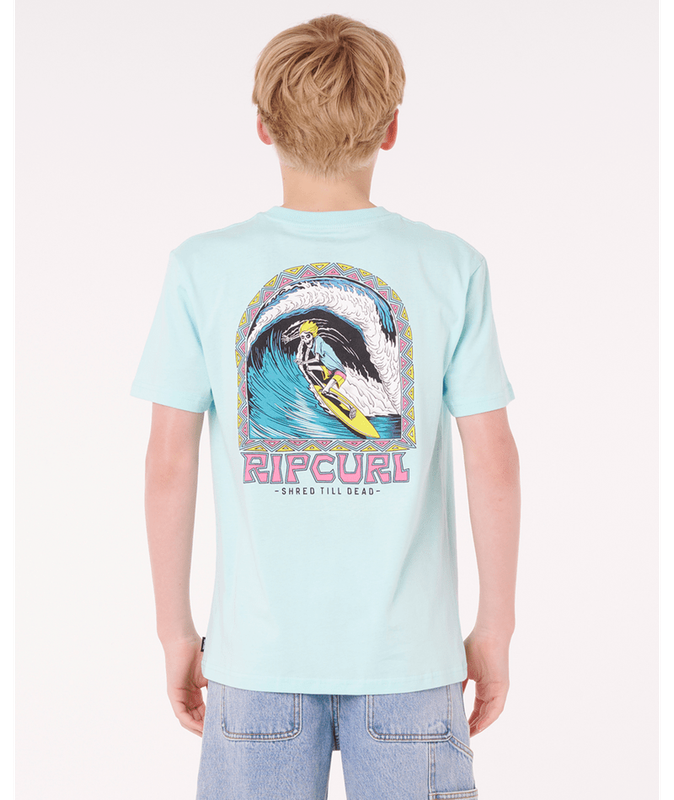 Youth model wearing a pale blue Ripcurl tee with a large, vibrant, surf-themed skeleton graphic on the back.