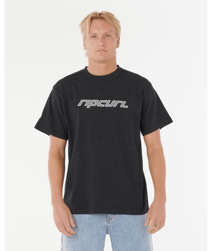 Model wearing the black RipCurl NU Dosed Tee, showcasing the relaxed fit and bold geometric silver graphic logo across crest 