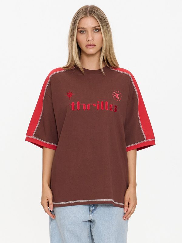 Close-up of model wearing the oversized brown Thrills Hot Shot Panelled Tee featuring red sleeve panels and red embroidery