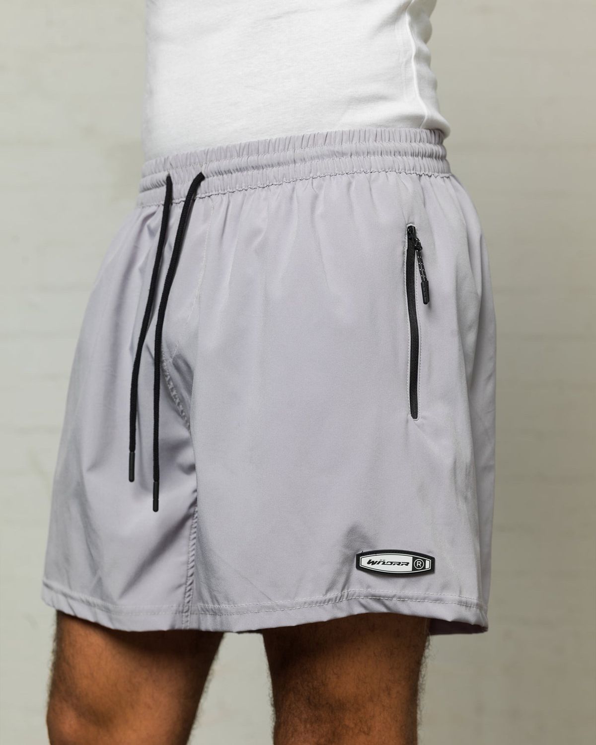 WNDRR Rothman Sport Short Grey close-up, featuring elastic waist, black drawcord, and secure zip utility pocket detail.