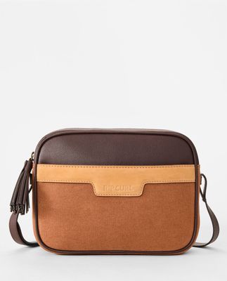 Front view of the RipCurl Boho Cross Body Bag featuring a tan faux leather top panel, textured chocolate textile bottom