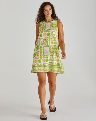 Close-up of the geometric and botanical tile print details on the Sass Emmett shift dress, highlighting the key green, shells