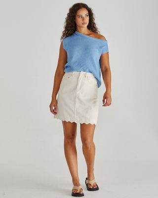 Front view of Sass Jaci off-the-shoulder knit top styled casually with a denim skirt.